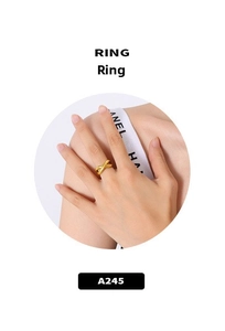 Detailed view of a gold-plated crossover X-shaped ring with a polished minimalist finish