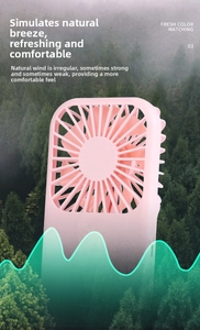 Detail view of pink portable mini fan with protective mesh grid against forest background