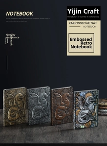 Detail shot of four vintage 3D embossed dragon notebooks in bronze and silver finishes