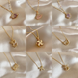 Golden titanium steel necklaces collection featuring heart and swan pendants with zircons