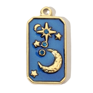 Detail showing vintage gold-plated star and moon pendant with blue enamel and rhinestones
