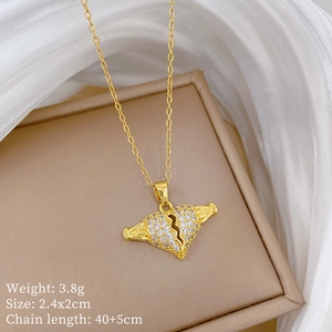 Detailed view of gold broken heart pendant with clear crystals and product dimensions