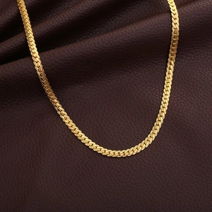 Classic 18K gold plated 20-inch flat curb chain necklace on brown leather surface
