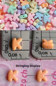Macro detail of macaron resin letter K beads for DIY jewelry with threading hole