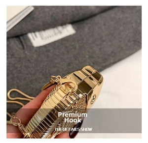 Detailed macro view of the golden fish-shaped bag with premium metal chain and lobster clasp