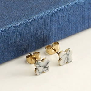 Detailed view of 14k gold clover earrings with white marble inlay and secure metal back