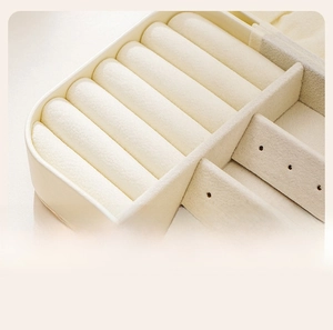 Detail view of the soft velvet interior with ring slots and earring holder board