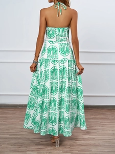 Detail of halter neck tie and open back design on green palm print maxi dress