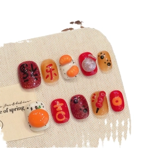 Faux ongles faits main pour le Nouvel An chinois avec charms orange 3D et calligraphie