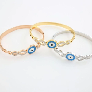 Three stainless steel evil eye bangle bracelets in gold, silver and rose gold finish