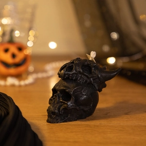 Detailed realistic black skull scented candle with cotton wick for Halloween decor