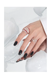 Macro detail of S925 silver rings with red enamel wave and micro-inlaid cubic zirconia