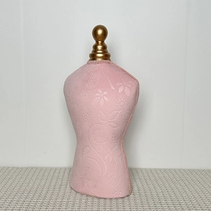 Detail of pink embossed velvet mannequin stand with golden finial for necklace display