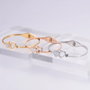 Elegant heart-shaped stainless steel bracelets in gold, rose gold, and silver finishes