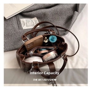 Detail view of brown leather bag interior showing compartments and storage capacity