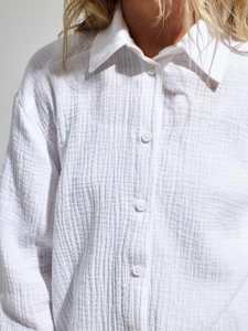Detail of white cotton crepe shirt showing lapel collar and breathable fabric texture