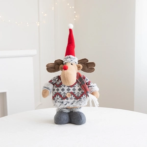 Detail of Christmas reindeer plush with Nordic knit sweater and red hat for window decor