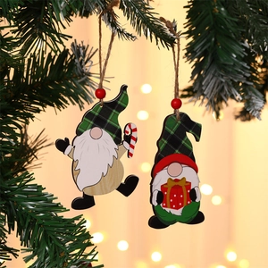 Close-up of wooden gnome ornaments with green plaid hats hanging on a Christmas tree