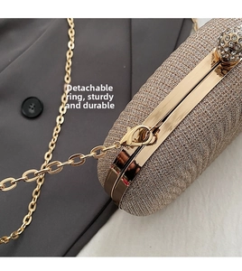 Detail of champagne gold evening bag with rhinestone clasp and detachable chain strap