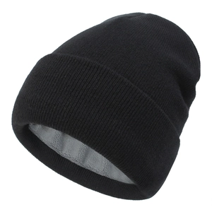 Detail of black knitted beanie showing the thick grey faux fleece warm lining inside