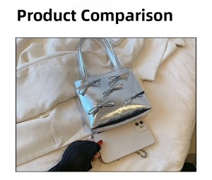 Silver metallic handbag with bow details shown next to a phone for size comparison
