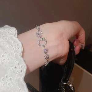 Detailed shot of Hello Kitty charm bracelet with pink zircon and silver metal chain