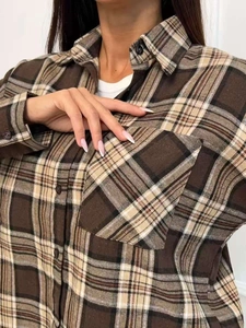 Detailed view of plaid shirt fabric texture, lapel collar and breast pocket detail