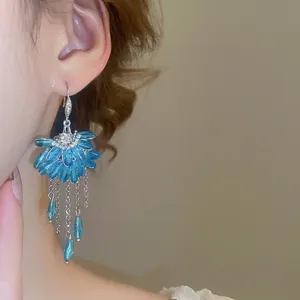 Blue zircon fan-shaped crystal tassel earrings displayed on a female model