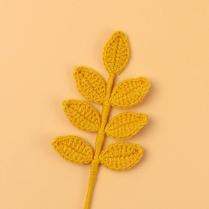 Detail view of a handmade yellow crochet seven-leaf branch for floral arrangements