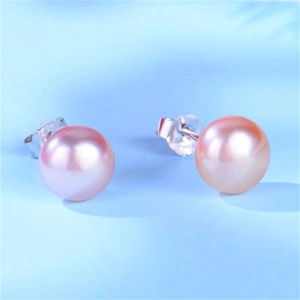 Close-up of natural pink freshwater pearl stud earrings with sterling silver butterfly backs