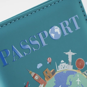 Macro view of blue passport cover showing premium leather texture and precise edge stitching
