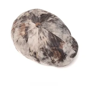 Top view detail of retro flat cap featuring grey and brown marble tie-dye texture