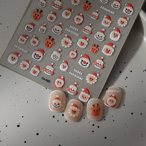 Detail of 3D embossed Christmas nail stickers featuring Santa Claus and snowman patterns