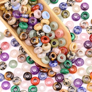Mix of colorful natural stone abacus beads with large holes displayed in a wooden spoon