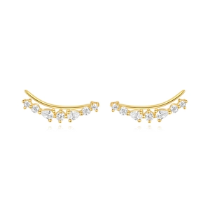 Macro shot of gold curved crawler earrings with sparkling zircon stones inlay