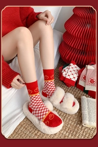 Detail of red festive socks with plaid and heart patterns featuring a traditional double happiness sign