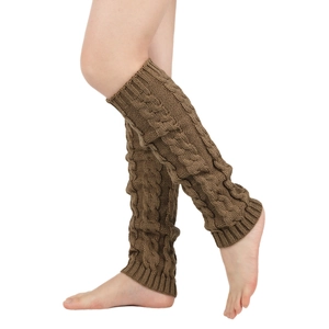 Detail view of brown chunky knit leg warmers with classic cable stitch texture