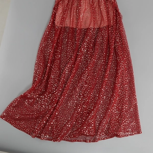 Close-up of red mesh dress hem featuring dense silver sequins and luxury beaded detail