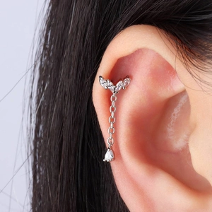 Detailed view of S925 silver helix piercing with sparkling blue star and tassel pendant