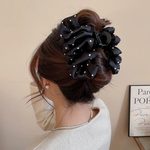 Polka dot fabric hair claw clip shown on head from side-back view in high-end style