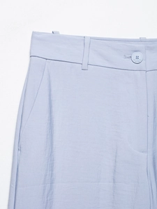 Close-up of lavender high-waisted trousers featuring button closure and belt loops