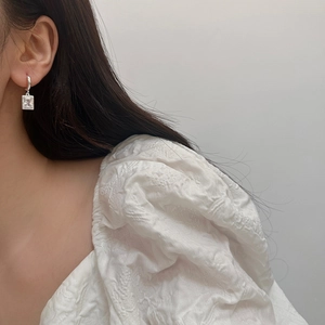 Elegant silver rectangle zircon drop earrings with micro-pave setting on a female model