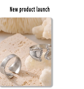 Detail of silver irregular set rings with crystals on textured stone and coral background