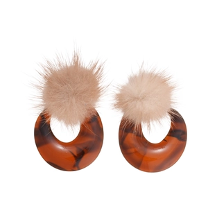 Retro resin earrings with amber pattern and beige fur balls on a white background