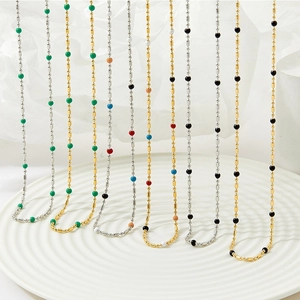 Bohemian colorful bead necklaces in gold and silver finish on a minimalist white tray