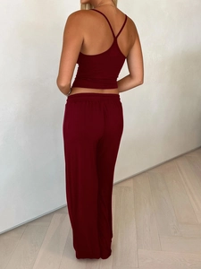 Back view of burgundy yoga set featuring a camisole top and wide-leg trousers