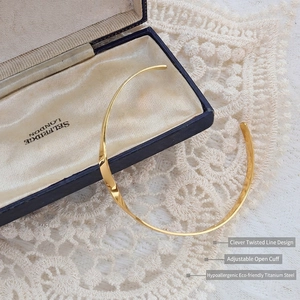 French minimalist 18k gold plated twisted steel bangle with adjustable open design