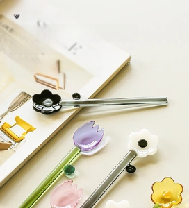 Detail of colorful glass dessert spoons featuring 3D floral tulip and daisy tops