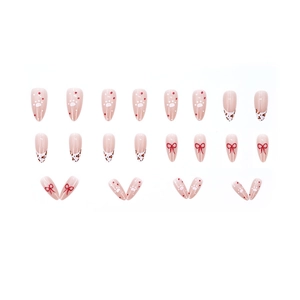 Almond press-on nails with leopard print, red bows, and cat paw designs on nude base