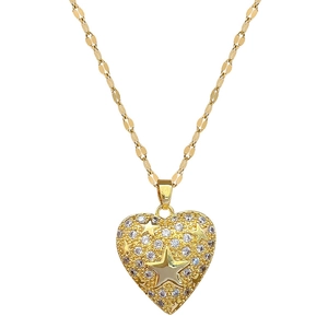 Luxurious gold heart pendant necklace with star patterns and sparkling pavé crystals